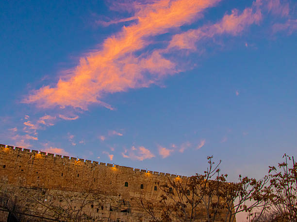 Twilight illuminates the clouds above the south walls of the old city, Jerusalem