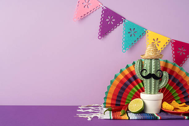 istock Cactus display with sombrero, mustache, and lime, surrounded by Cinco de Mayo colors and decorations 2207690377