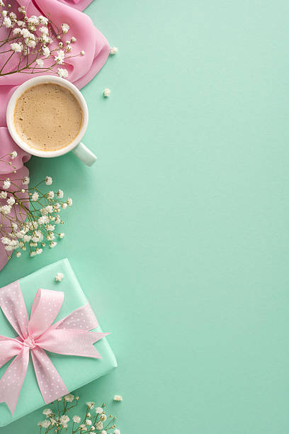 istock A charming vertical composition featuring a coffee cup, delicate flowers, and a wrapped gift. Perfect for Mother's Day, spring celebrations, and gift-giving themes 2207690389