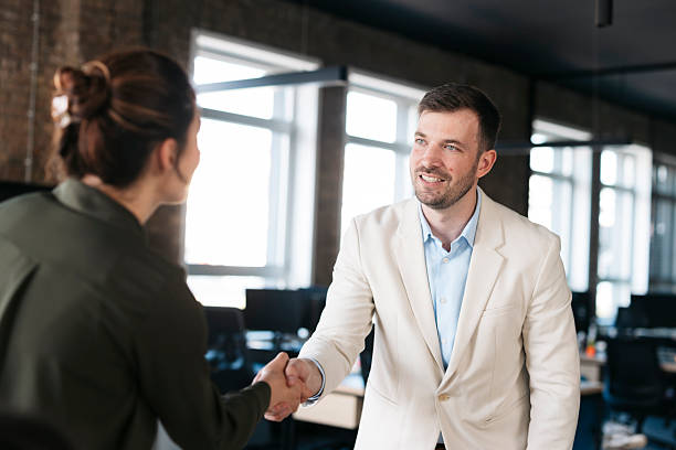 istock Businesspeople shaking hands during meeting in modern office 2207695376