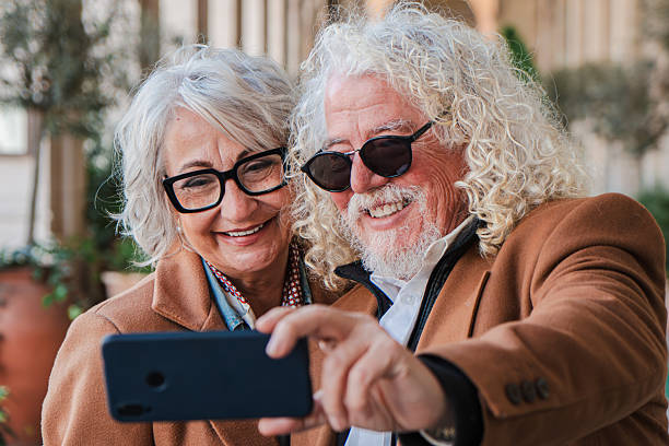 istock Joyful senior couple taking a fun selfie together with a smartphone, capturing a memorable moment filled with laughter and happiness while enjoying each other's company and sharing special memories 2207696465