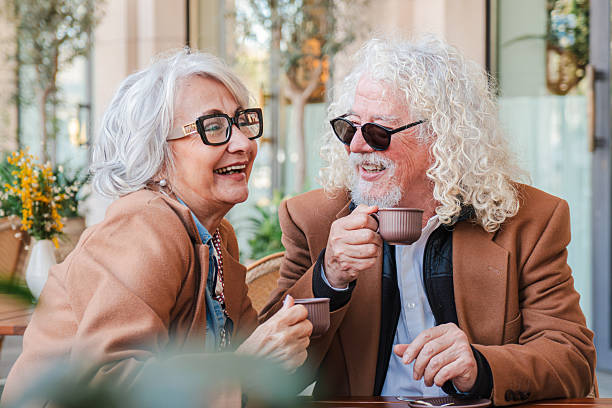 istock Joyful and affectionate seniors sharing a delightful coffee date, savoring each moment with laughter and connection in a cozy coffee shop atmosphere filled with warmth and love 2207696489