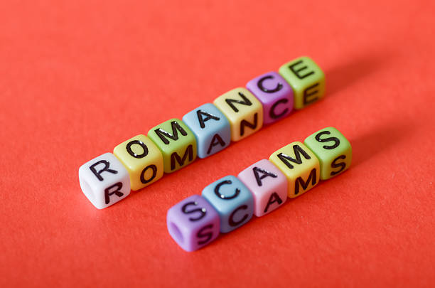 istock Beware of Romance Scams  Caution Sign and Letter Blocks on Red Background 2207700094