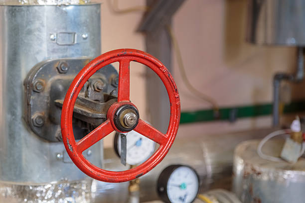 istock Red big faucet on the pipe in the basement 2207700322