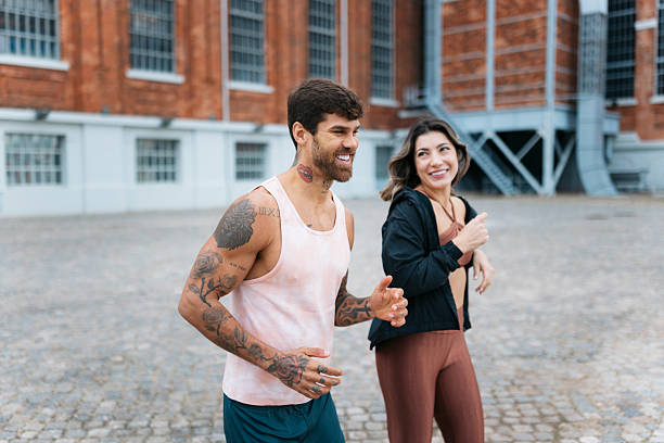 istock Couple running together outdoors in urban setting 2207700539