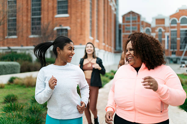 istock Three young women running together outdoors and smiling 2207701662