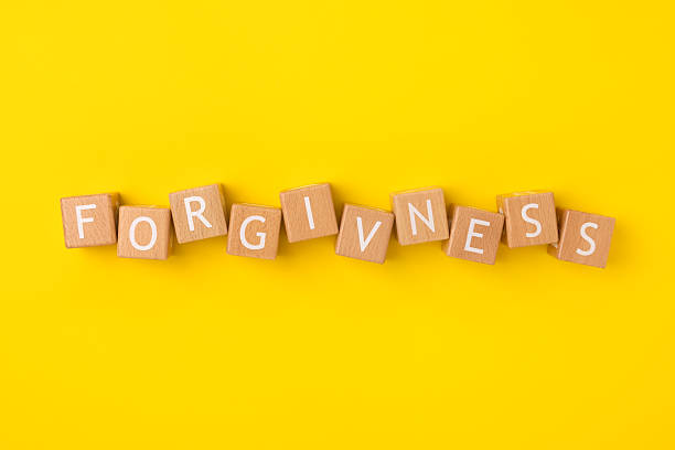 istock Block Words with Forgiveness on a Yellow Background 2207701681