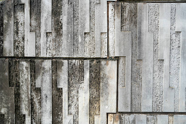 The textured surface of weathered concrete, with its rugged, aged appearance and intricate patterns of cracks and subtle variations. The muted grey tones and raw, industrial feel make it a versatile choice for design elements such as backgrounds, overlays, or wallpapers