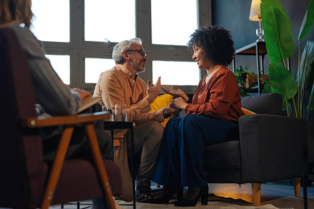 istock Mature couple discussing with psychologist during therapy session 2207702895