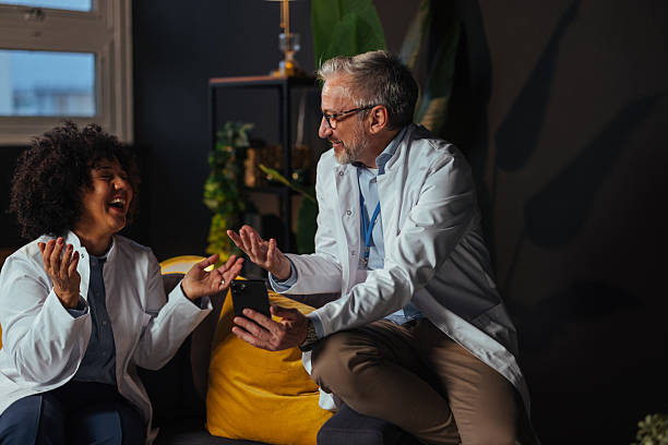 istock Doctors laughing and using smart phone in the hospital staff room 2207702963