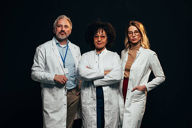 istock Confident medical team posing on black background 2207702965