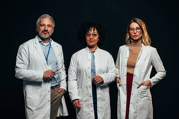 istock Confident medical team posing on black background 2207702990