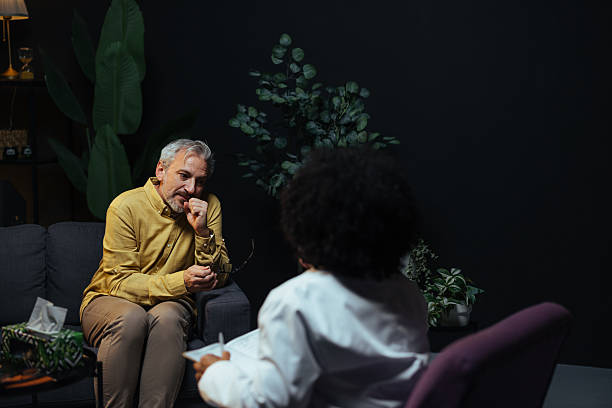 istock Mature man talking to his therapist during therapy session 2207703000