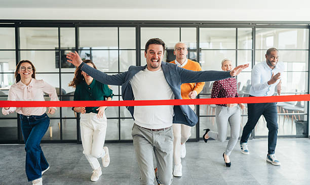 istock Team Celebration Crossing the Finish Line in an Office Setting 2207703536