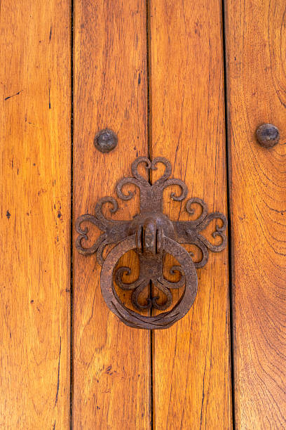 istock A wooden door with a metal handle and a decorative design 2207705808