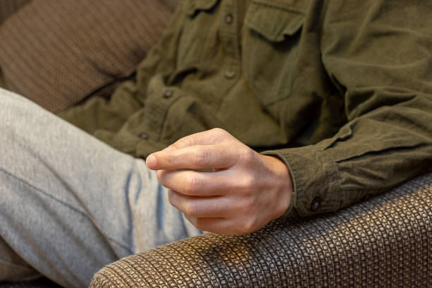 istock A man sitting on a sofa with his arm resting on the armrest 2207706212