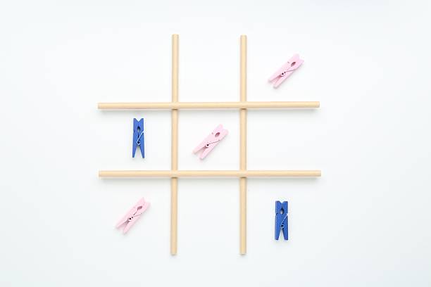 istock Tic tac toe game made with clothespins on white background, top view 2207707831