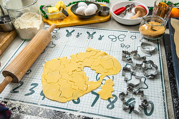 Baking Christmas cookies with dough and cookie cutters during the festive season