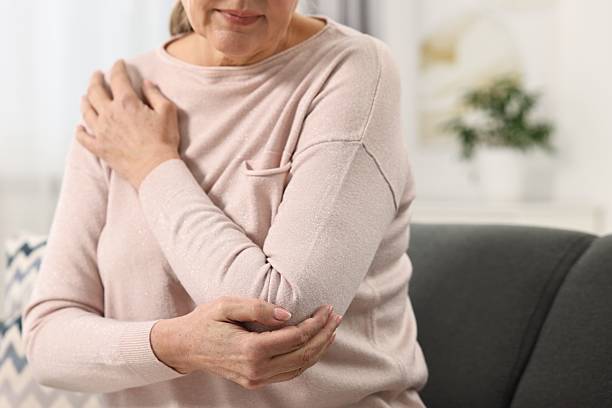istock Arthritis symptoms. Woman suffering from pain in elbow at home, selective focus 2207709414