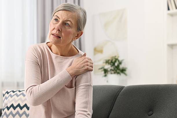 istock Arthritis symptoms. Woman suffering from pain in shoulder at home 2207709421