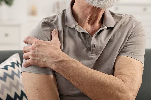 istock Arthritis symptoms. Man suffering from pain in shoulder at home, closeup 2207711738
