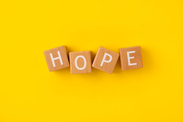 istock Block Words with Hope on a Yellow Background 2207712944