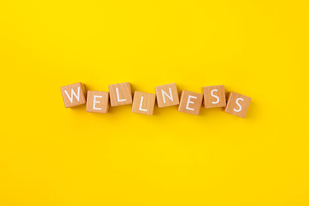 istock Block Words with Wellness on a Yellow Background 2207713645