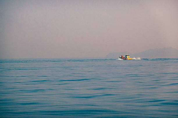 Small fishing boat or coastal fishing boat in sea on weather day is clear and the sea is slightly rough.