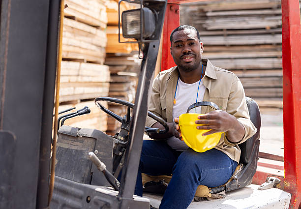 istock Man working at a lumberyard driving a forklift 2207714172
