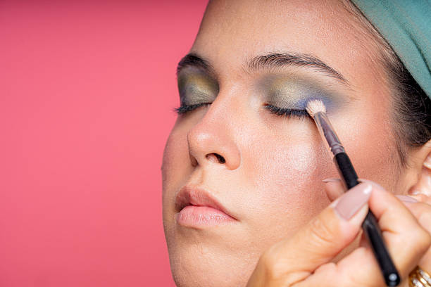 istock Makeup artist applying eyeshadow on young woman 2207718836