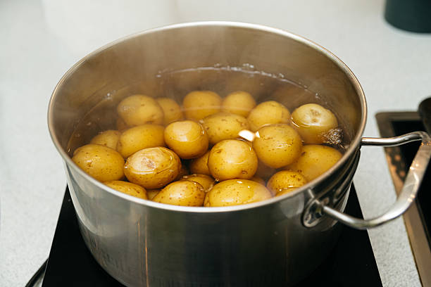 istock Boiling baby potatoes in stainless steel pot. 2207719944