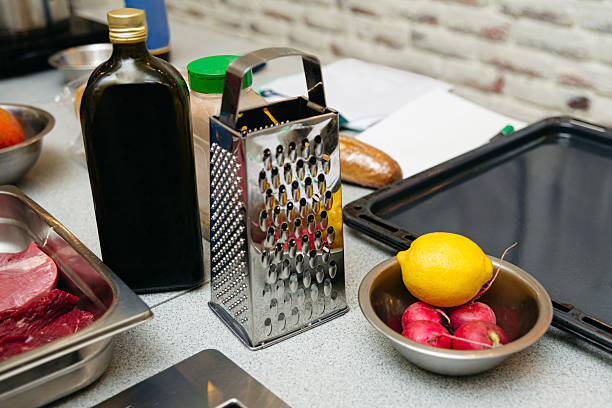 istock Kitchen counter with grater, oil and fresh ingredients. 2207719946