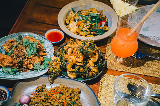 istock Dinner includes fried shrimp, stir-fried pork with red curry paste, shrimp with tamarind sauce, and chicken stir-fried with cashew nuts. 2207720775