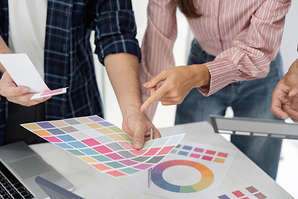 istock Detail Orientation and Team Dynamics. Colleagues analyzing color charts together. 2207721059