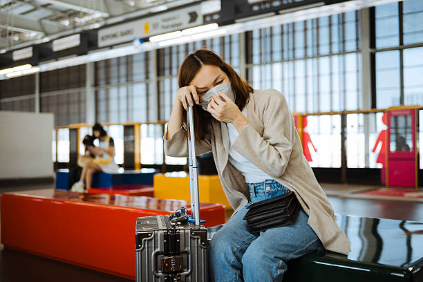 istock Asian woman with protective mask in public station. 2207721271