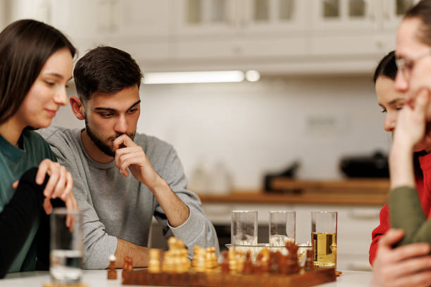 istock Friends playing chess at home 2207723222