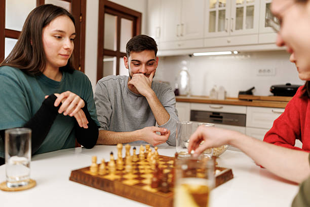 istock Friends playing chess at home 2207723252