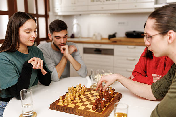 istock Friends playing chess at home 2207723287