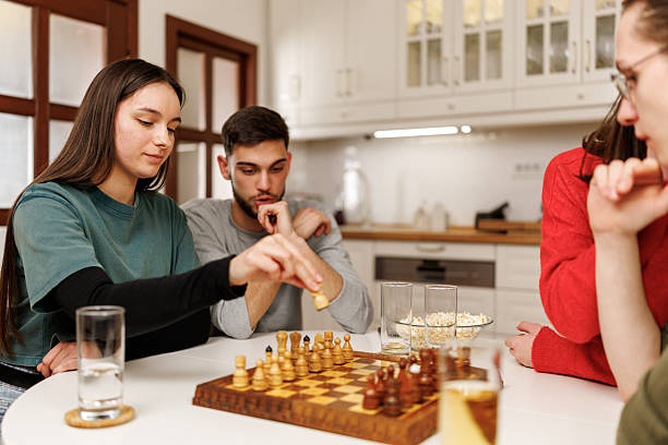 istock Friends playing chess at home 2207723883