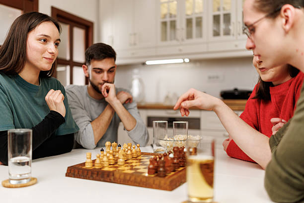 istock Friends playing chess at home 2207723936