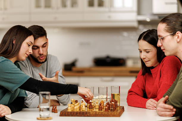istock Friends playing chess at home 2207723981