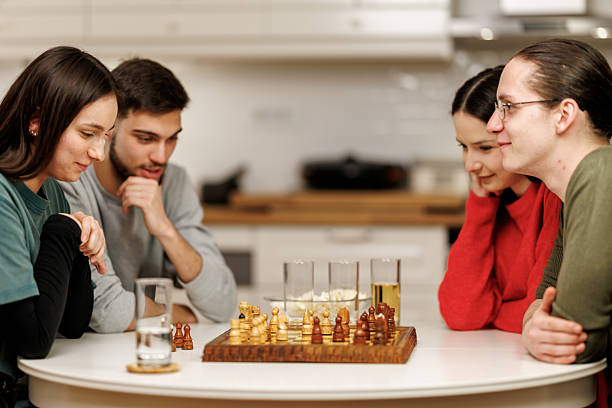 istock Friends playing chess at home 2207724027