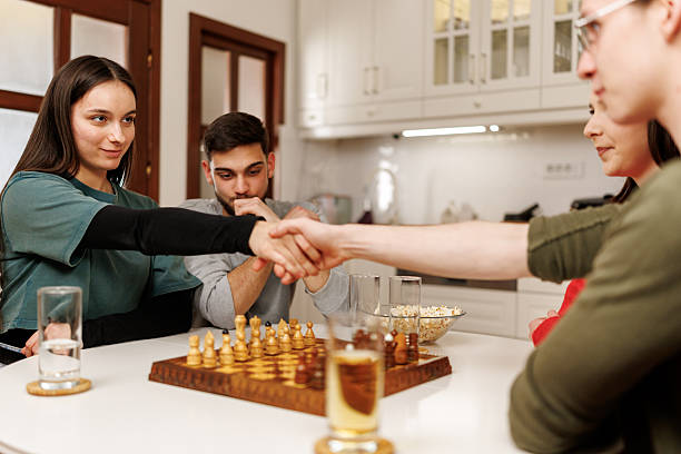 istock Friends handshaking over chess board before the game 2207724061