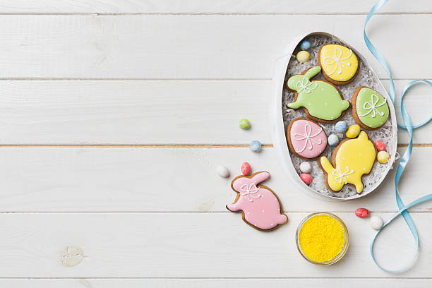 istock Colorful easter cookies in basket with Multi colors Easter eggs on colored background . Pastel color Easter eggs. holiday concept with copy space 2207729228