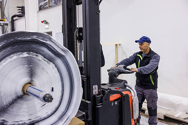 istock Man operating forklift in distribution warehouse for electrical insulation tape 2207729859
