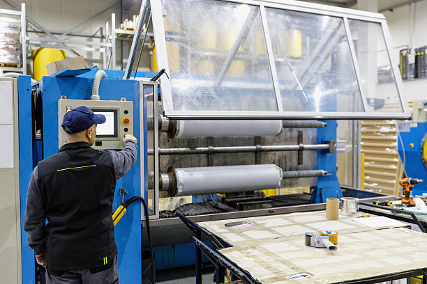 istock Man working in production line, electrical insulating tape on the spools 2207729904