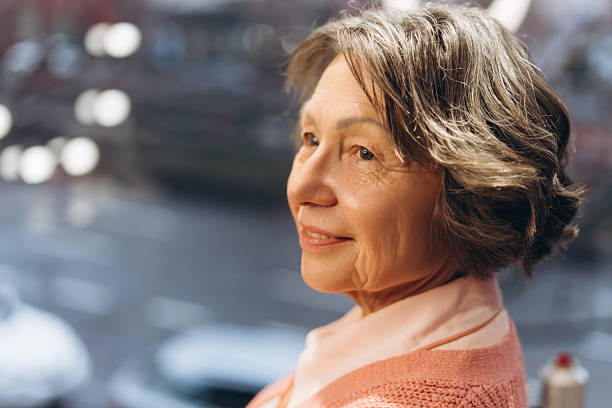 istock Mature woman enjoying peaceful urban view 2207730806