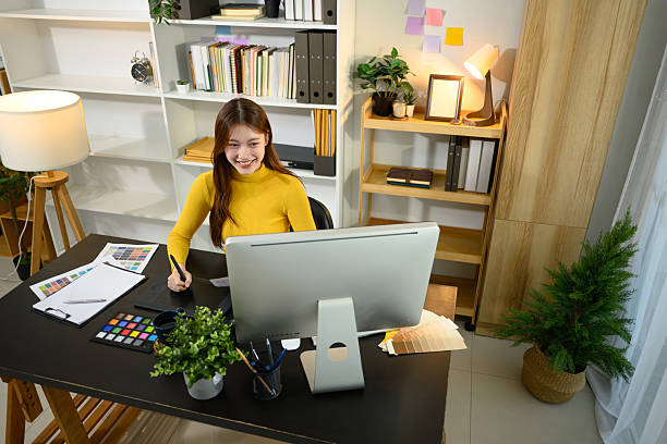 istock Smiling young designer working on digital tablet and color samples at home office 2207730942