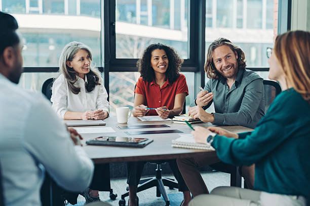 istock Group of entrepreneurs sitting at a table and having a discussion 2207733520