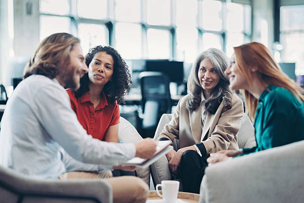 istock Group of entrepreneurs having a meeting in an open office space 2207733521